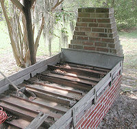 Outdoor photo of series of rectangular metal trays divided by short internal metal sheets